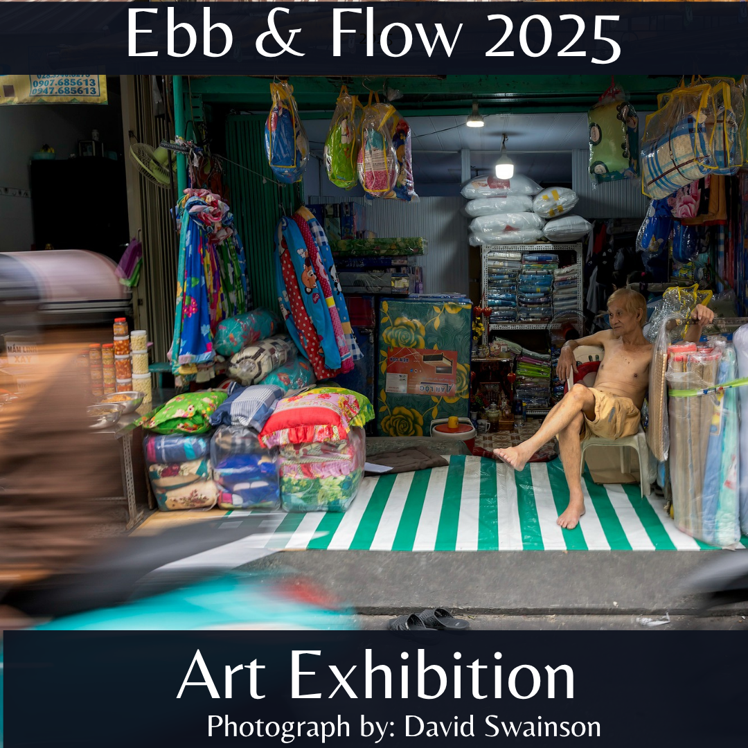 Ebb and Flow 2025 Exhibition poster showing a photograph from David Swainson of a shop selling brightly colored printed blankets, rugs, and pillows with an elderly slender person sitting in bare feet, shorts, and no shirt casually. A blur from a motorcycle or scooter zooms by.
