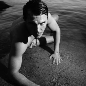 Digital black and white photo - Portrait of male model in lake water crawling - http://www.edwardolive.info/ Edward Olive - Digital black and white photo - Portrait of male model in lake water crawling